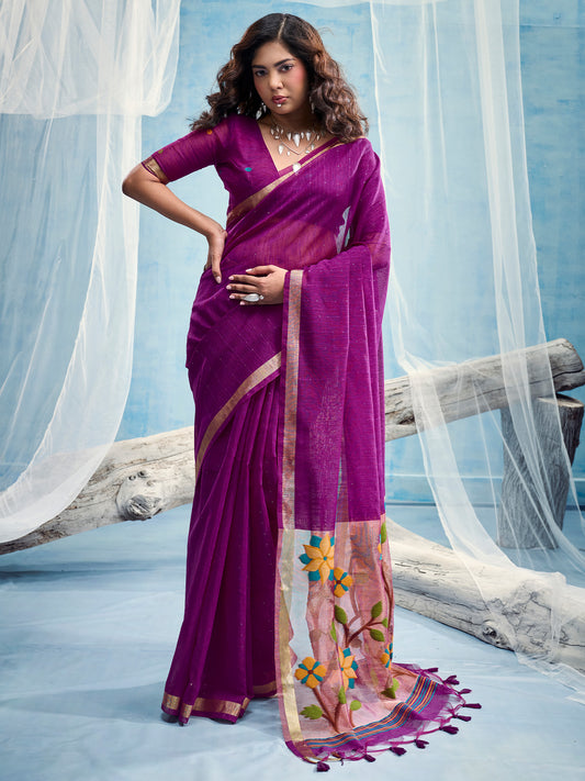 Woman wearing purple muga silk saree with clean solid-tone finish and purple blouse
