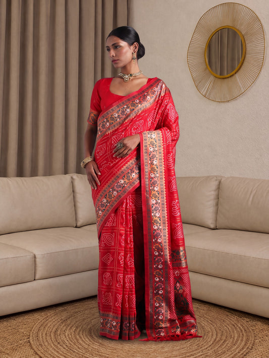 Woman wearing red dola silk saree with bandhani tie-dye dot work and red blouse