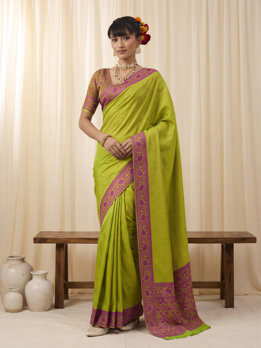 Woman wearing lime green silk blend saree with traditional indian motif work and lime green blouse
