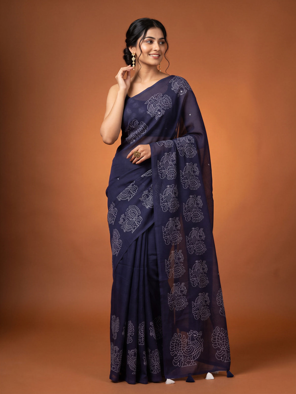 Woman wearing purple linen blend saree with traditional indian motif work and purple blouse