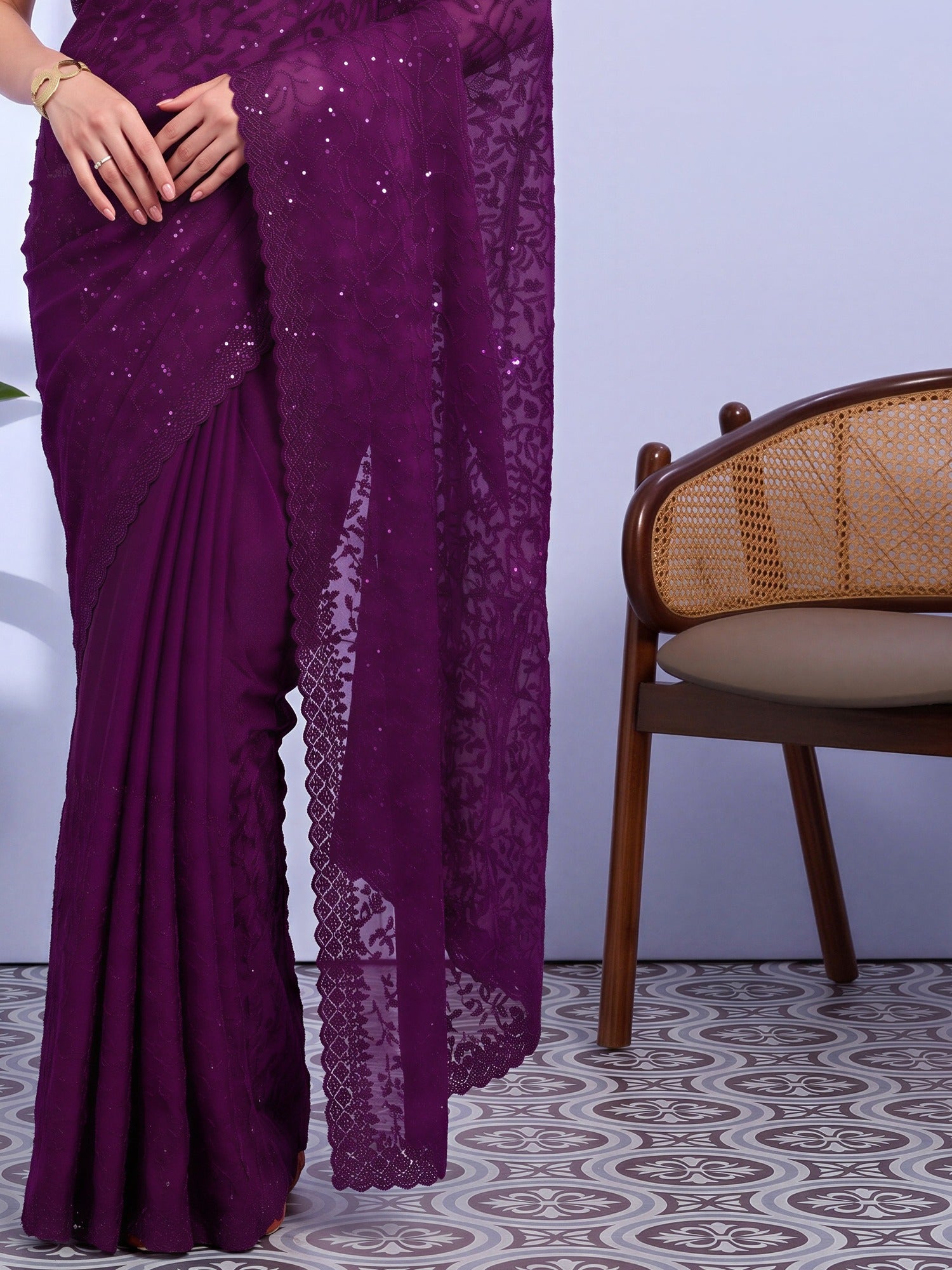 Pallu detail of purple tissue saree showing ornamented surface design and embellished border