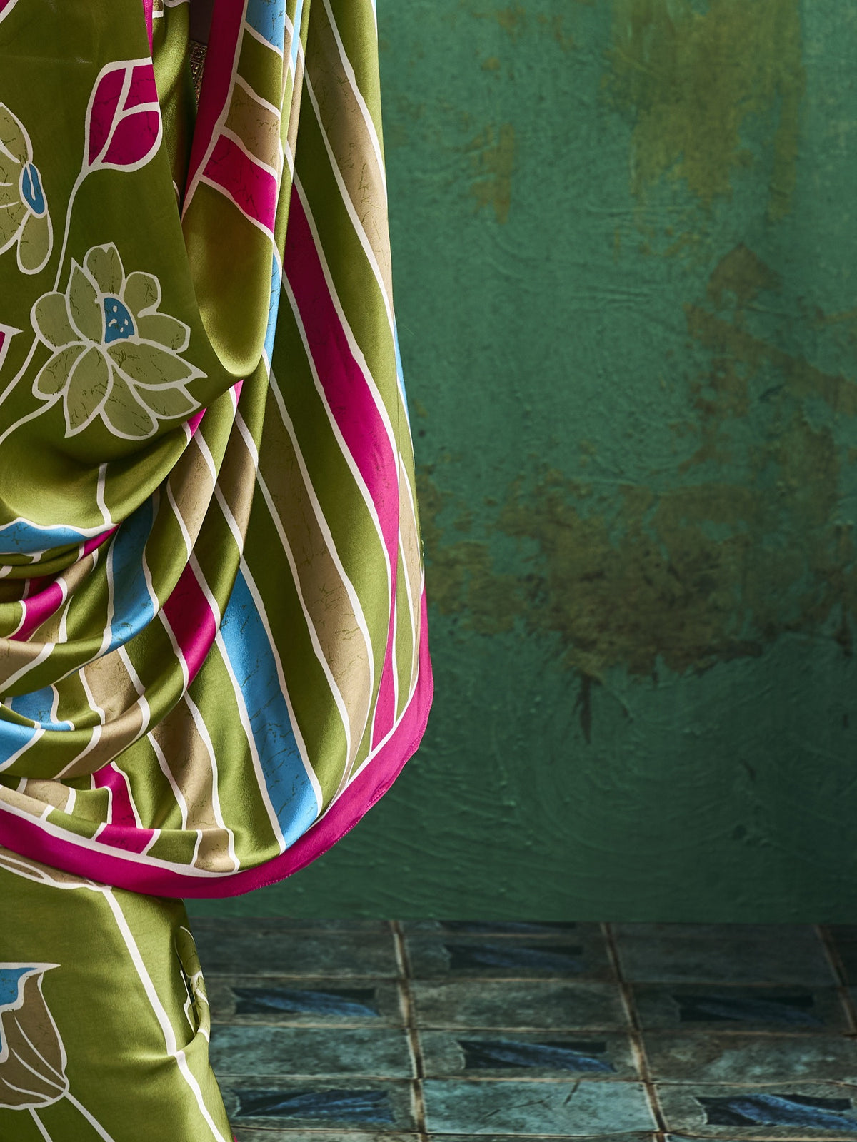 Pallu detail of light green satin saree showing all-over floral design and printed border