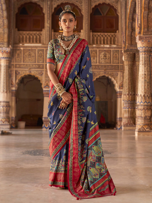Woman wearing navy blue silk blend saree with traditional indian motif work and multicolored blouse