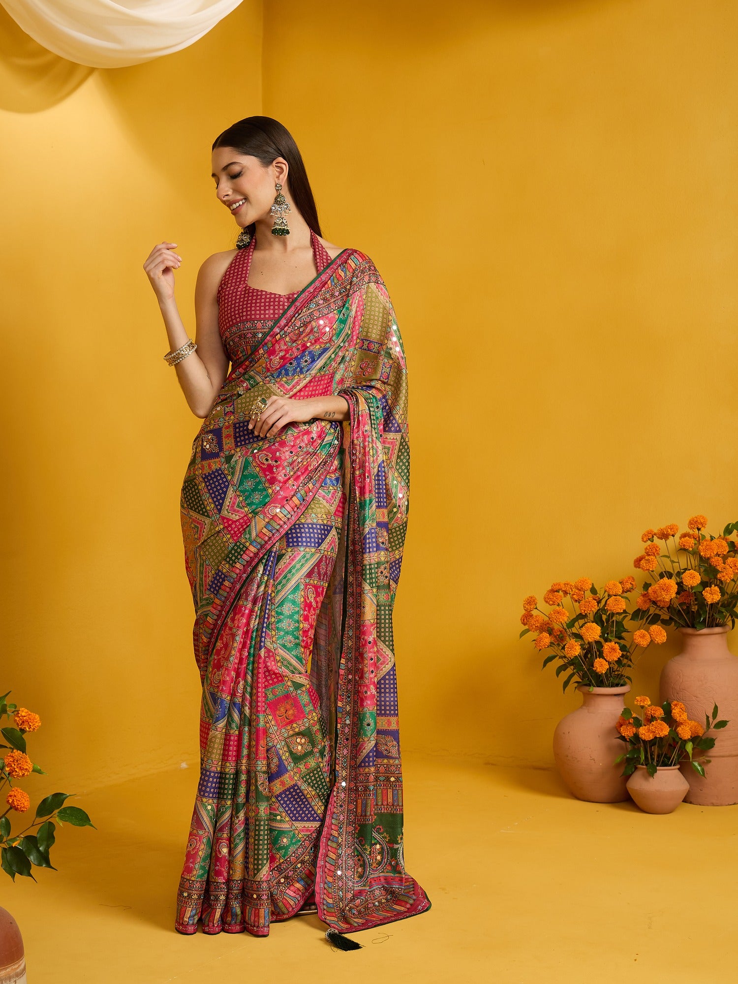 Woman wearing multicolored silk blend saree with ornamented surface design and pink blouse