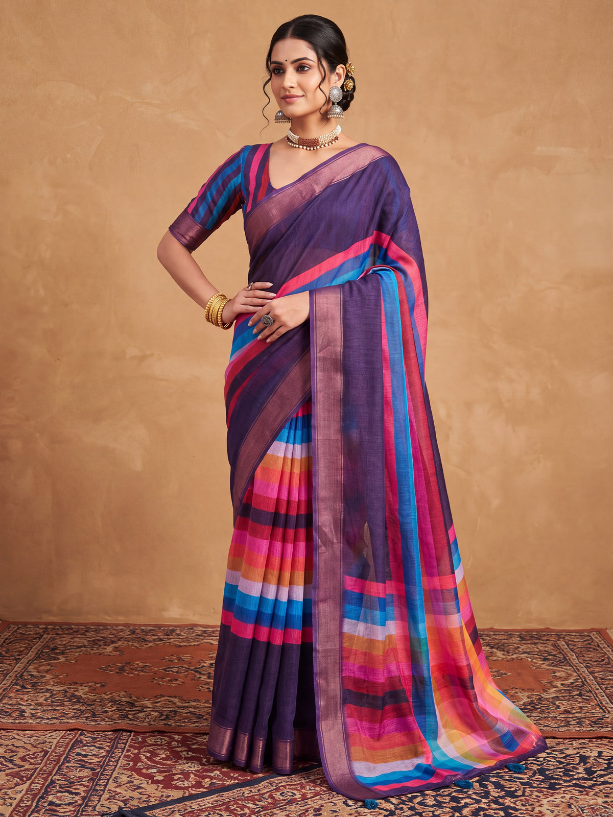 Woman wearing purple linen saree with colorblocked design and multicolored blouse