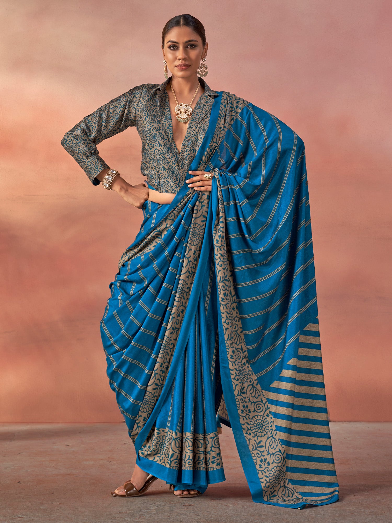 Woman wearing teal blue silk blend saree with traditional indian motif work and teal blue blouse