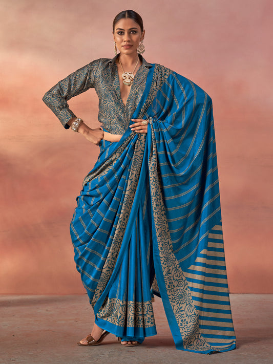 Woman wearing teal blue silk blend saree with traditional indian motif work and teal blue blouse