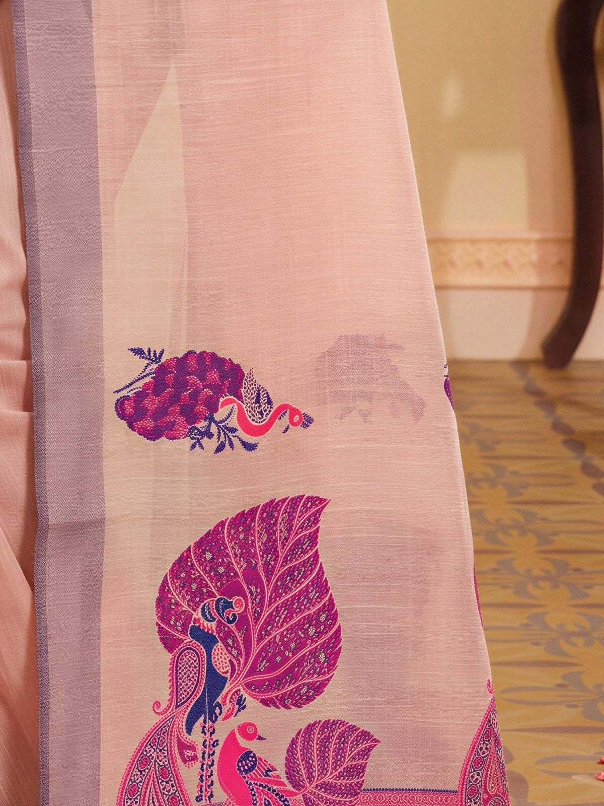 Pallu detail of rose silk blend saree showing traditional indian motif work and woven design border