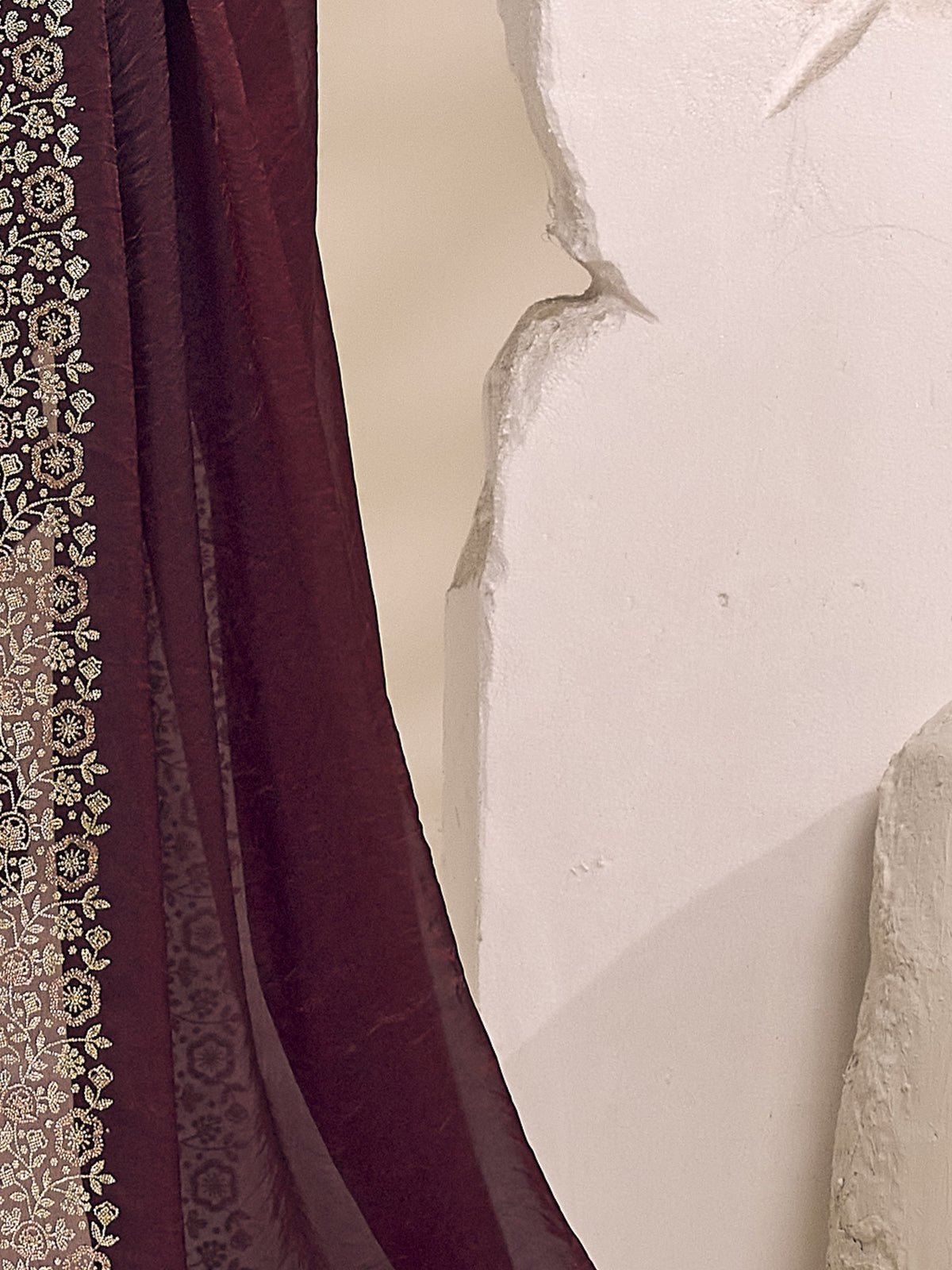 Pallu detail of wine satin silk saree showing clean solid-tone finish and embellished border