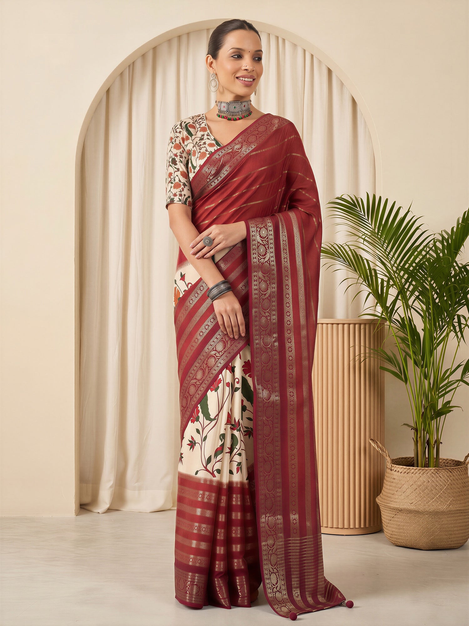 Woman wearing maroon viscose silk saree with traditional indian motif work and cream blouse