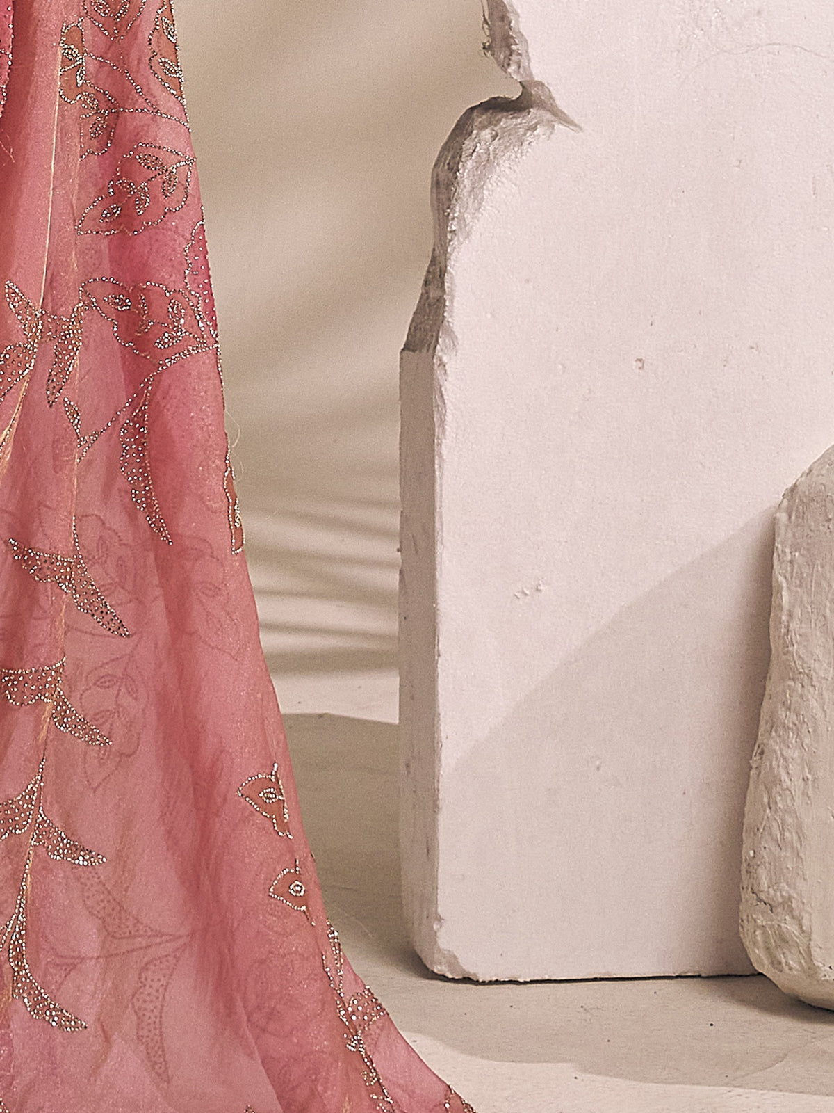 Pallu detail of pink organza saree showing ornamented surface design and scallop border