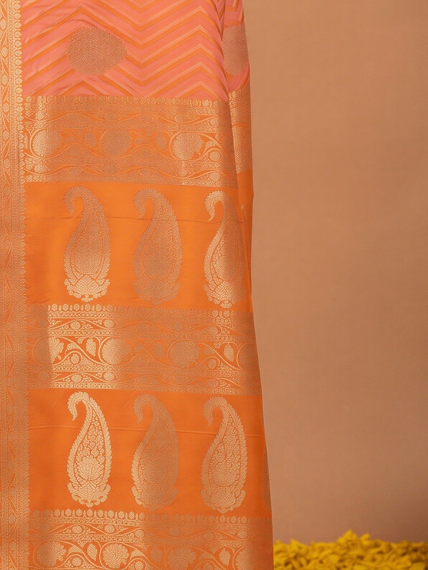 Pallu detail of peach silk blend saree showing geometric pattern design and zari border