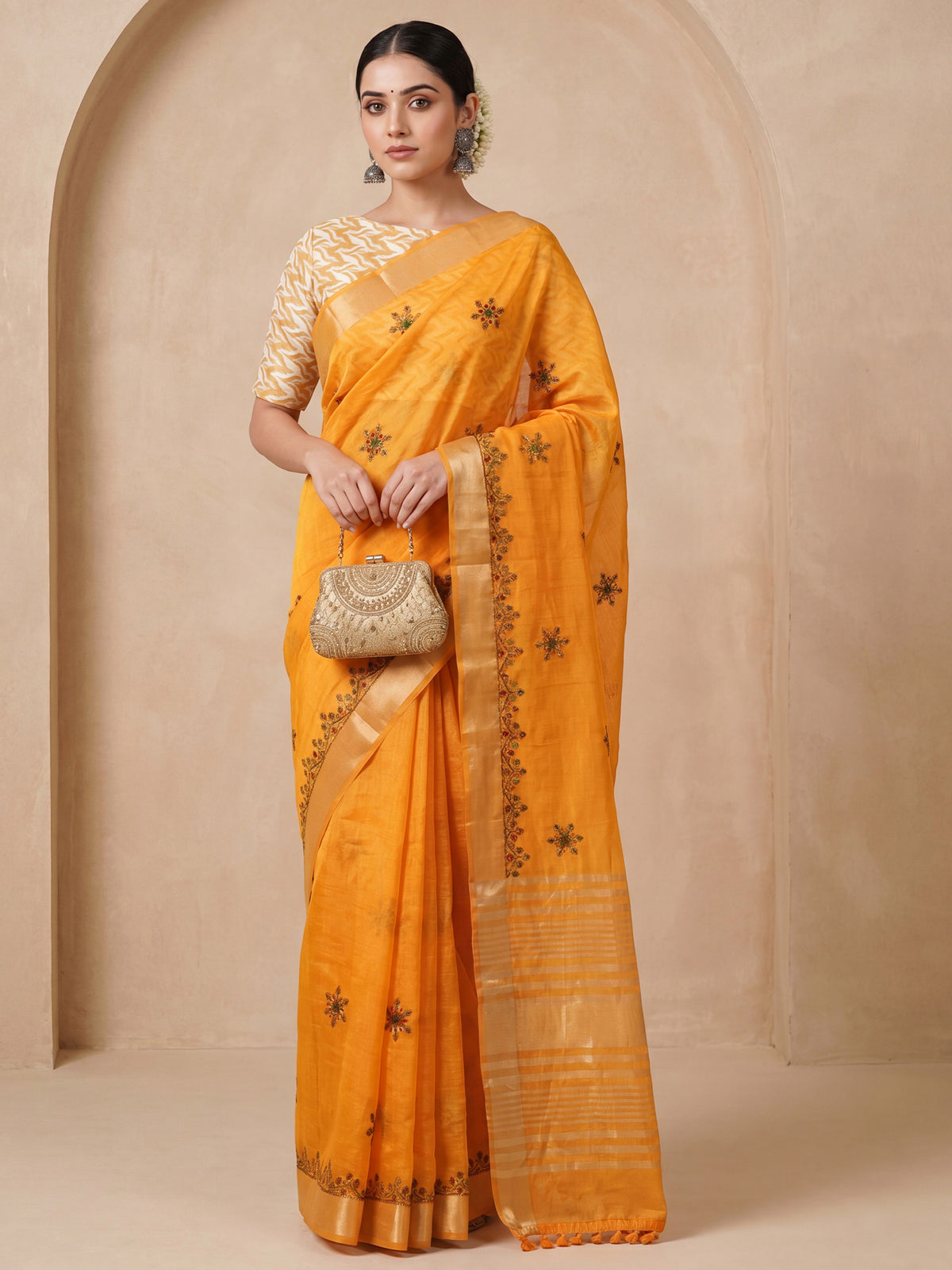 Woman wearing mustard cotton linen saree with embroidered motif work and mustard blouse