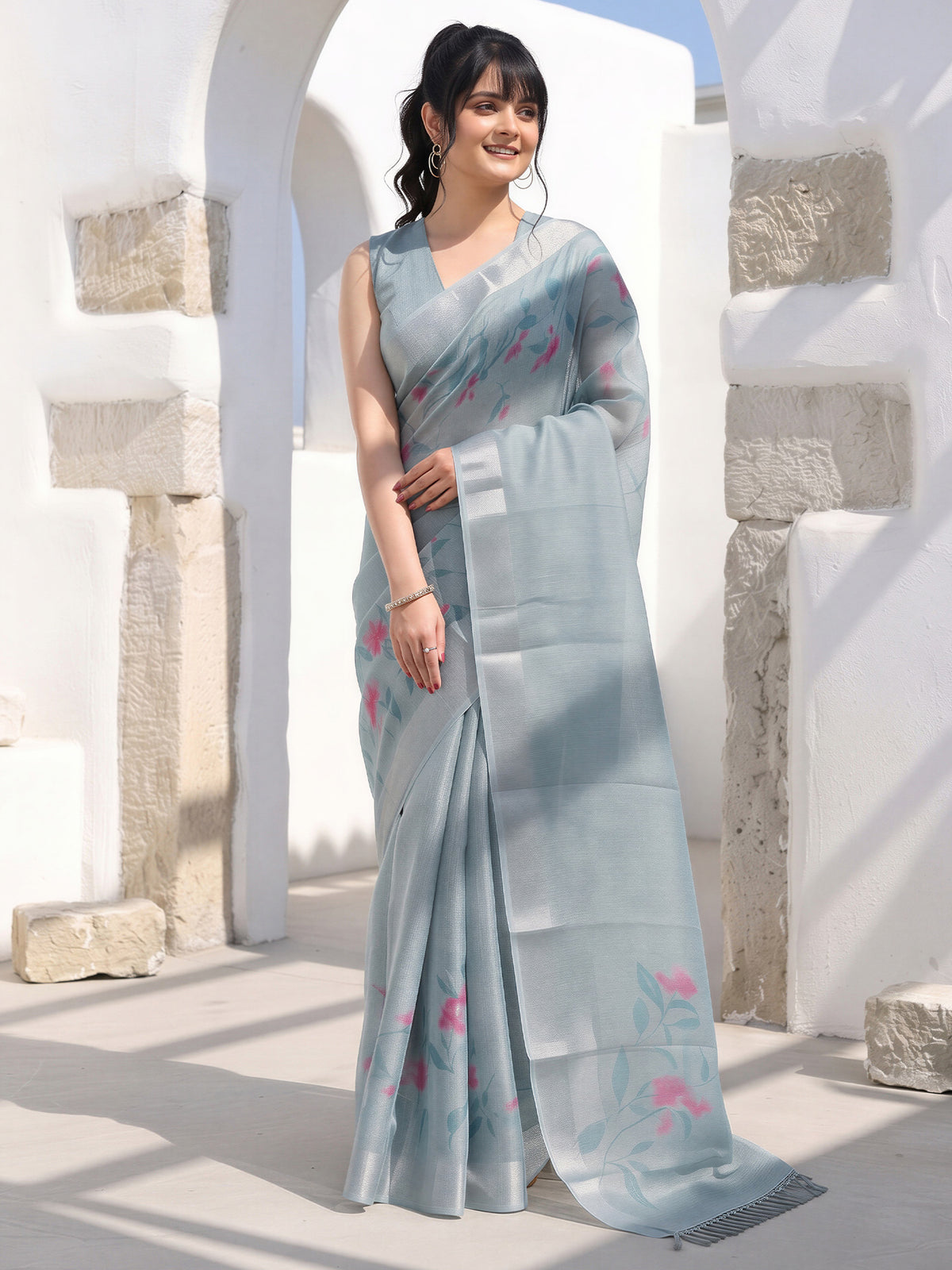Woman wearing teal blue cotton silk saree with traditional indian motif work and teal blue blouse