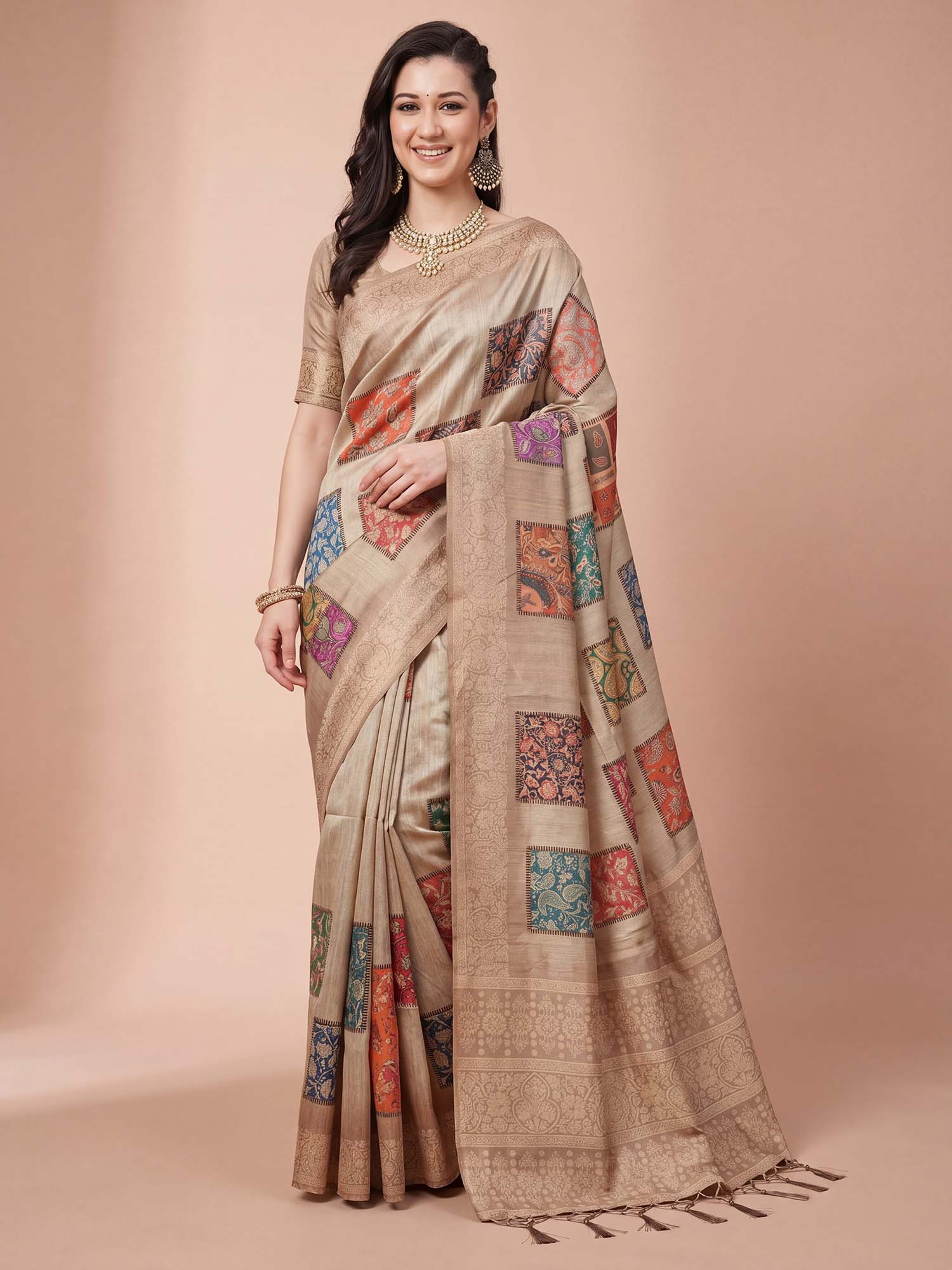 Woman wearing beige cotton silk saree with traditional indian motif work and beige blouse