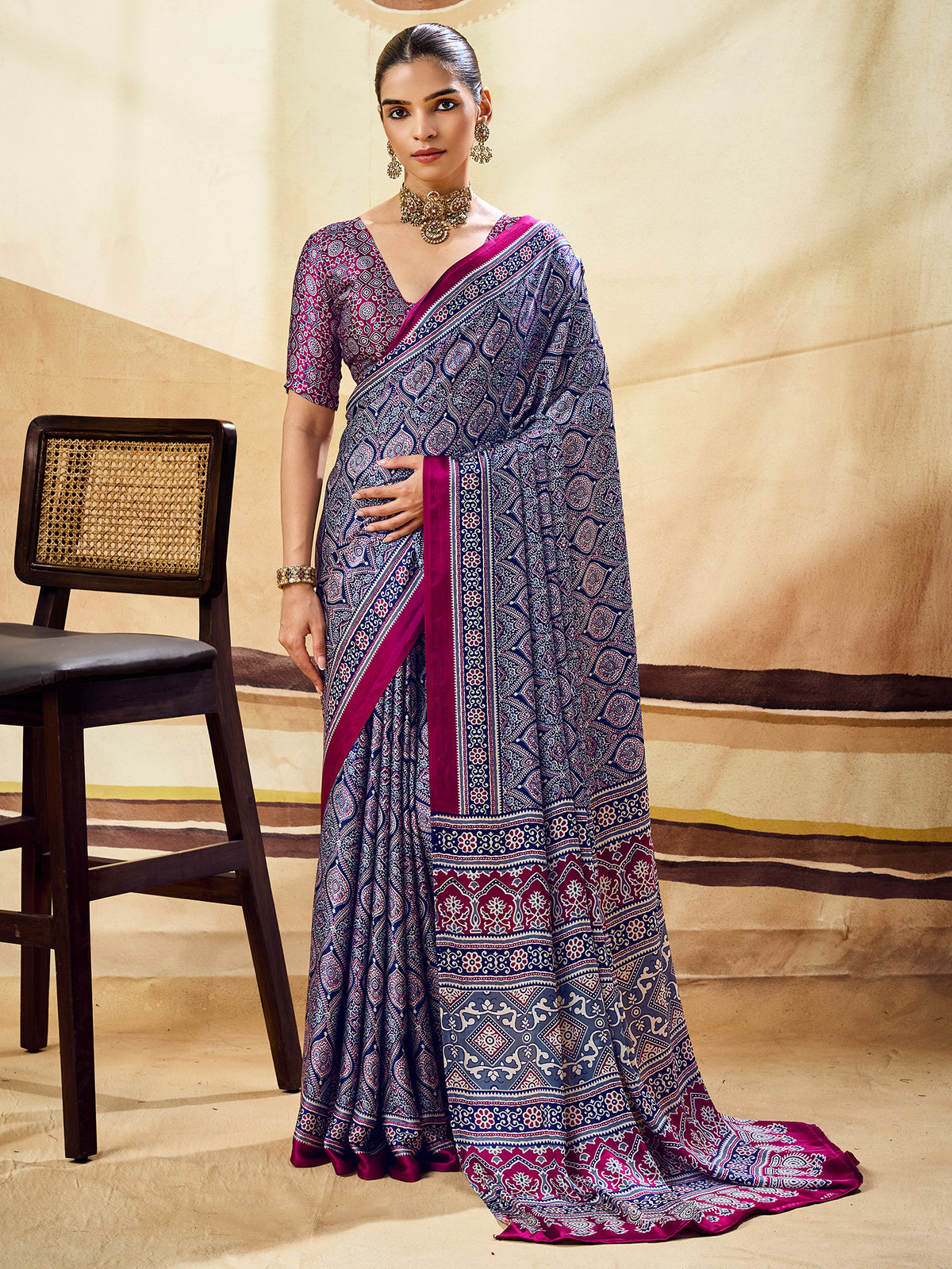 Woman wearing blue satin saree with ajrak block-print motif work and wine blouse