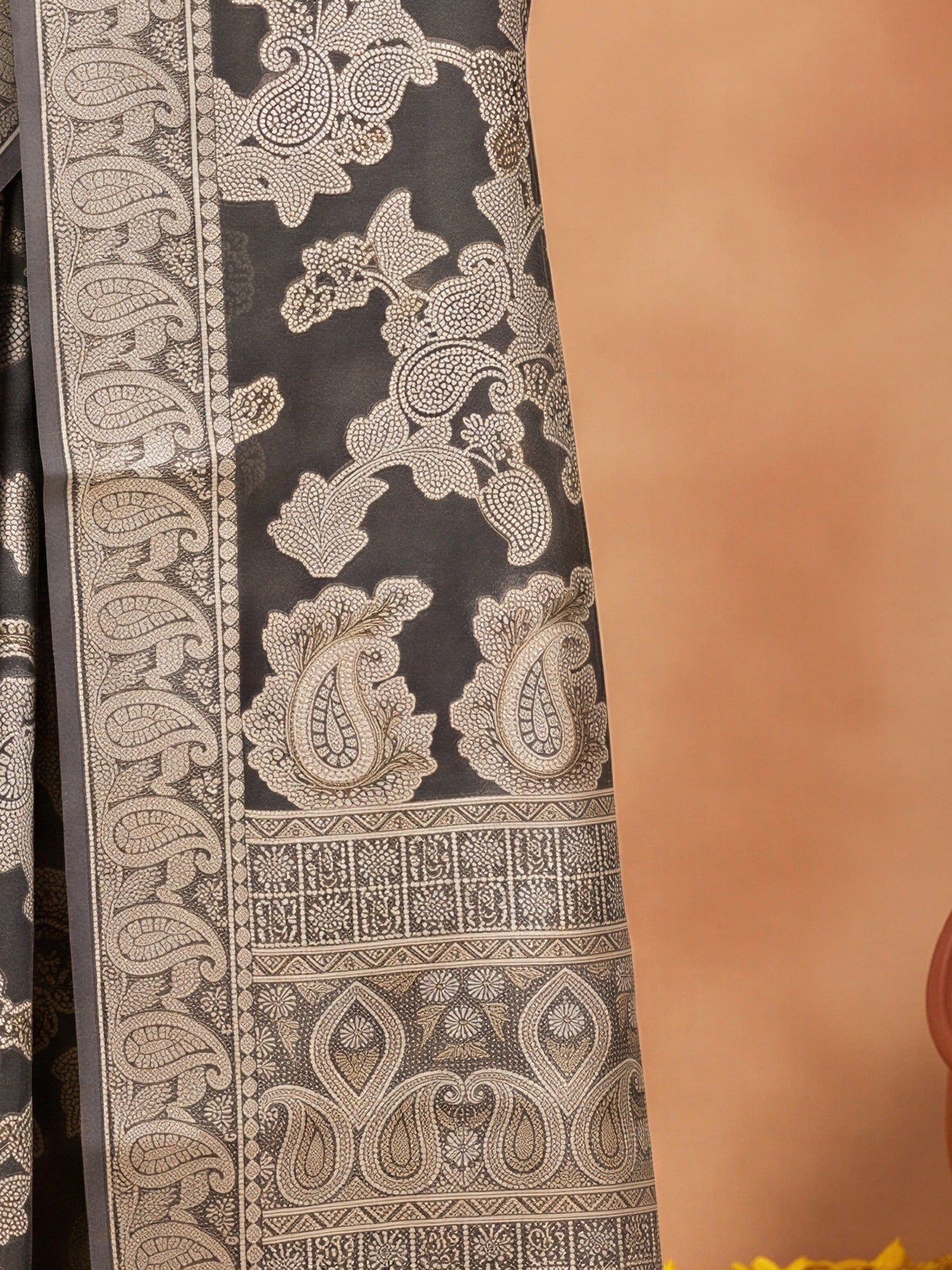 Pallu detail of black organza saree showing traditional indian motif work and zari border