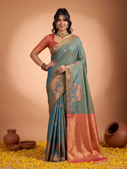 Woman wearing teal blue silk saree with animal-print design and rust blouse