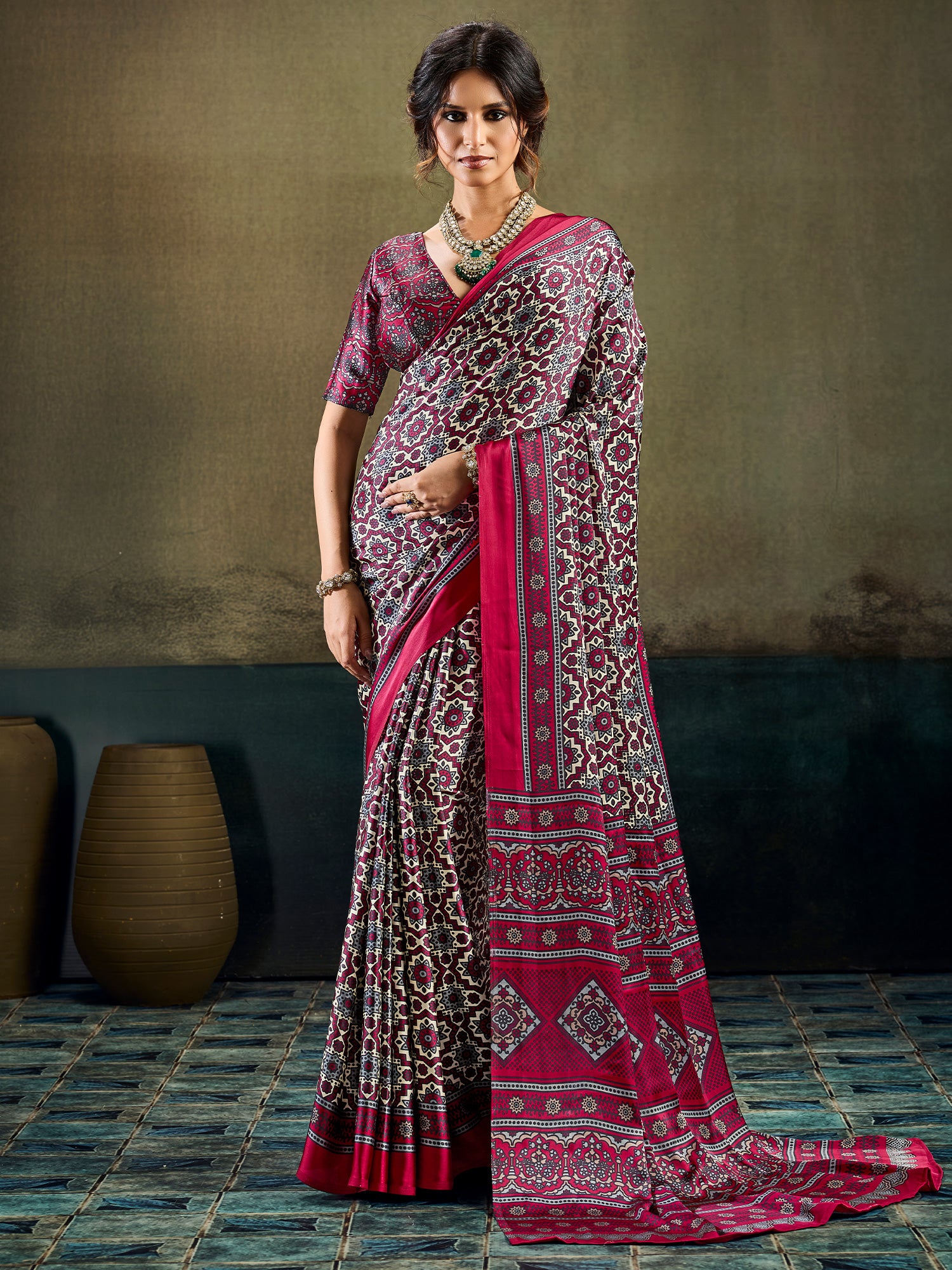 Woman wearing burgundy satin saree with ajrak block-print motif work and burgundy blouse