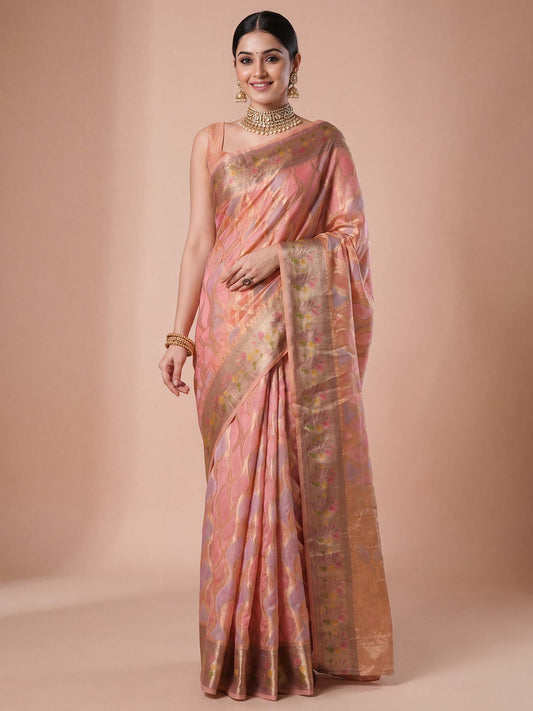 Woman wearing pink organza saree with traditional indian motif work and pink blouse