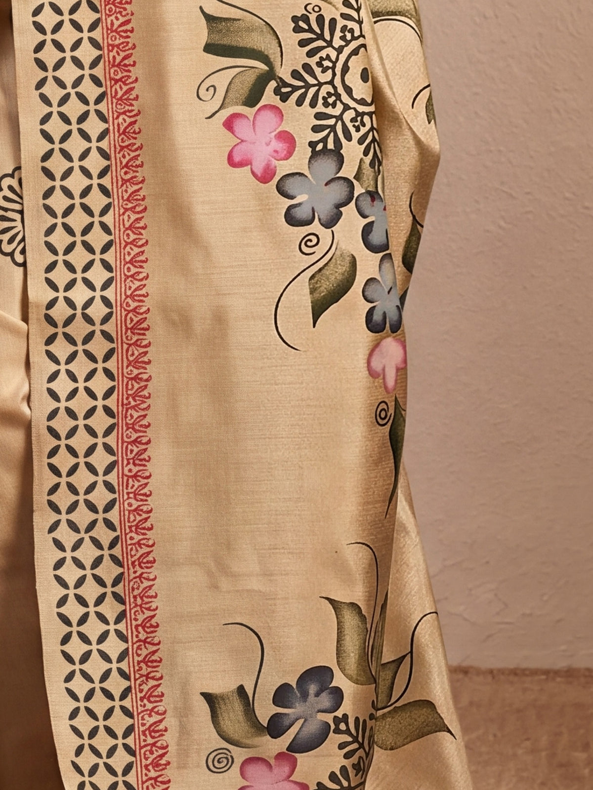 Pallu detail of beige silk blend saree showing hand-painted motif work and printed border