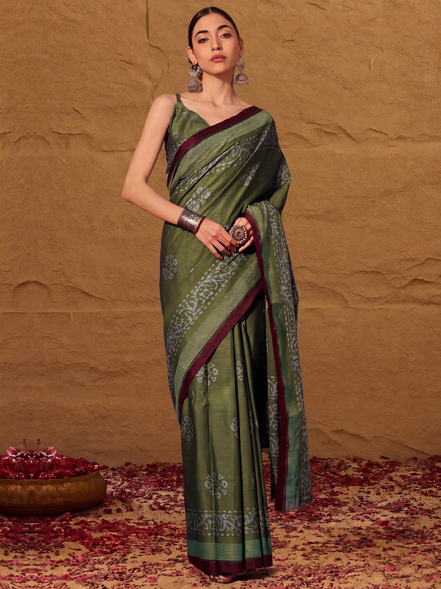 Woman wearing olive cotton saree with batik wax-resist design and olive blouse