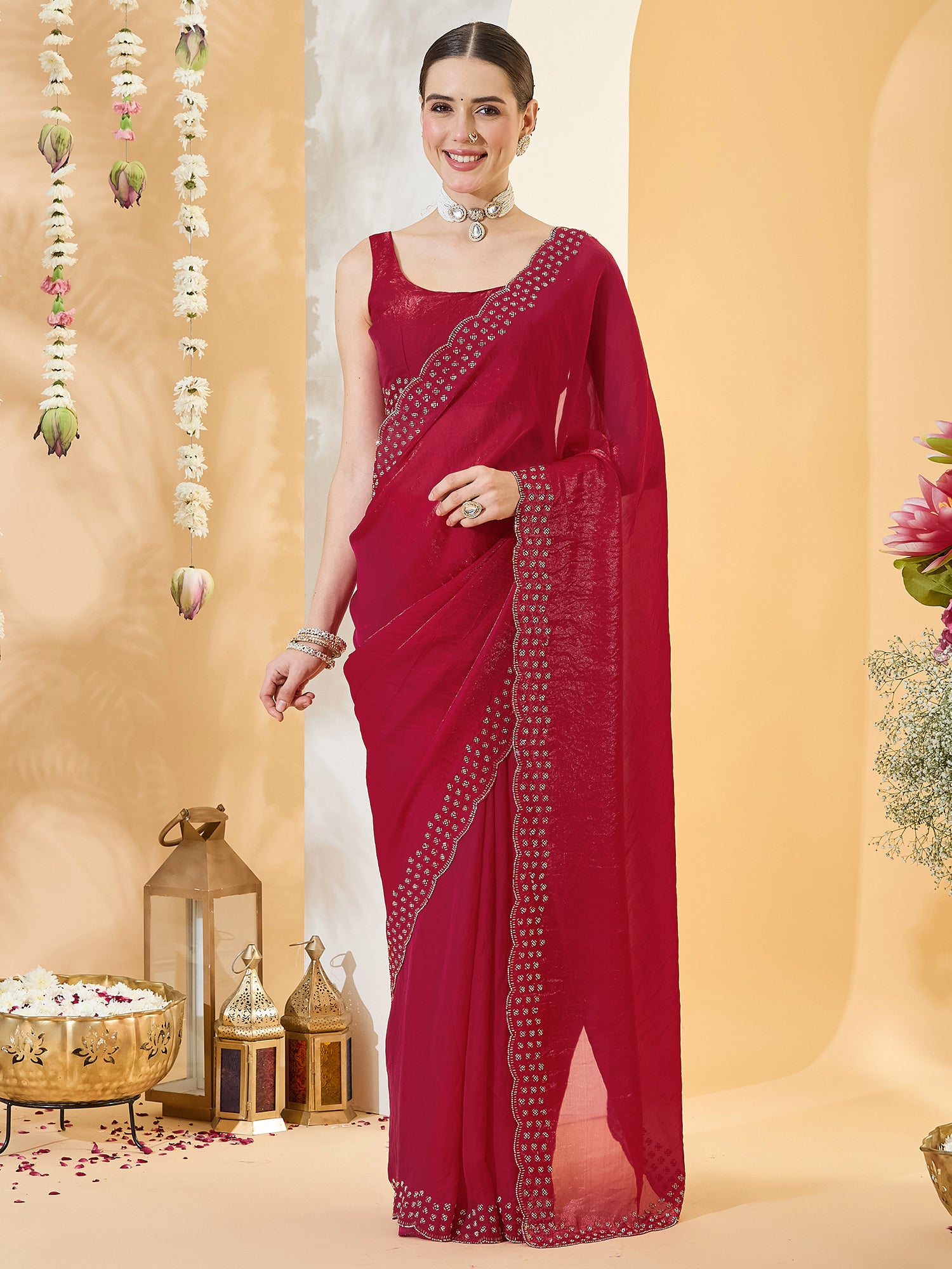 Woman wearing red satin saree with clean solid-tone finish and red blouse