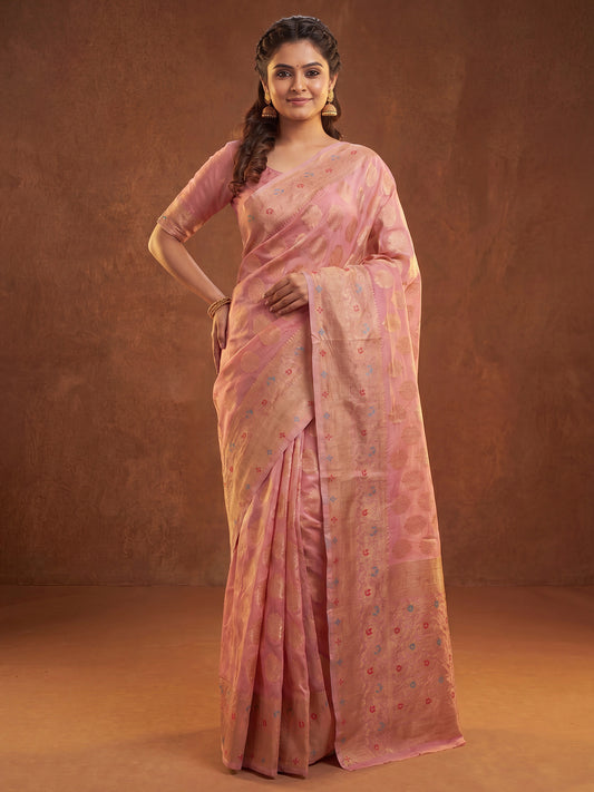 Woman wearing pink silk blend saree with zari butta (metallic motif) work and pink blouse