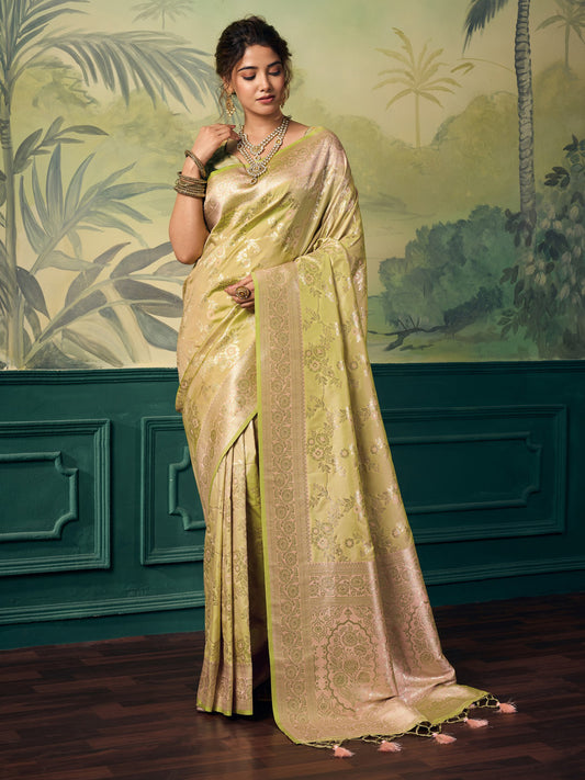 Woman wearing lime green banarasi silk saree with woven motif design and lime green blouse