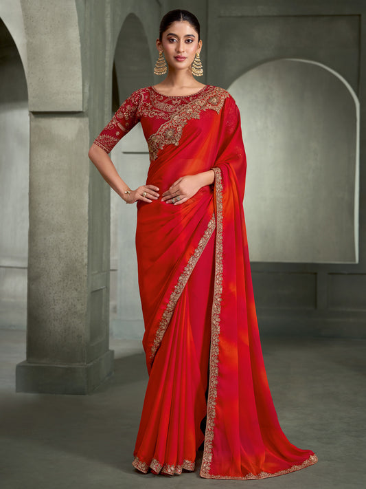 Woman wearing red chiffon saree with embroidered motif work and red blouse