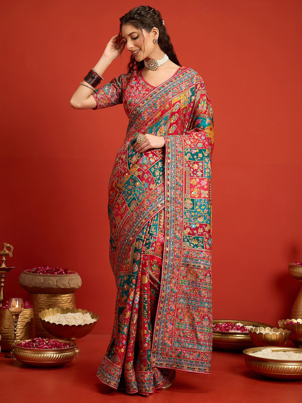 Woman wearing pink silk blend saree with traditional indian motif work and pink blouse