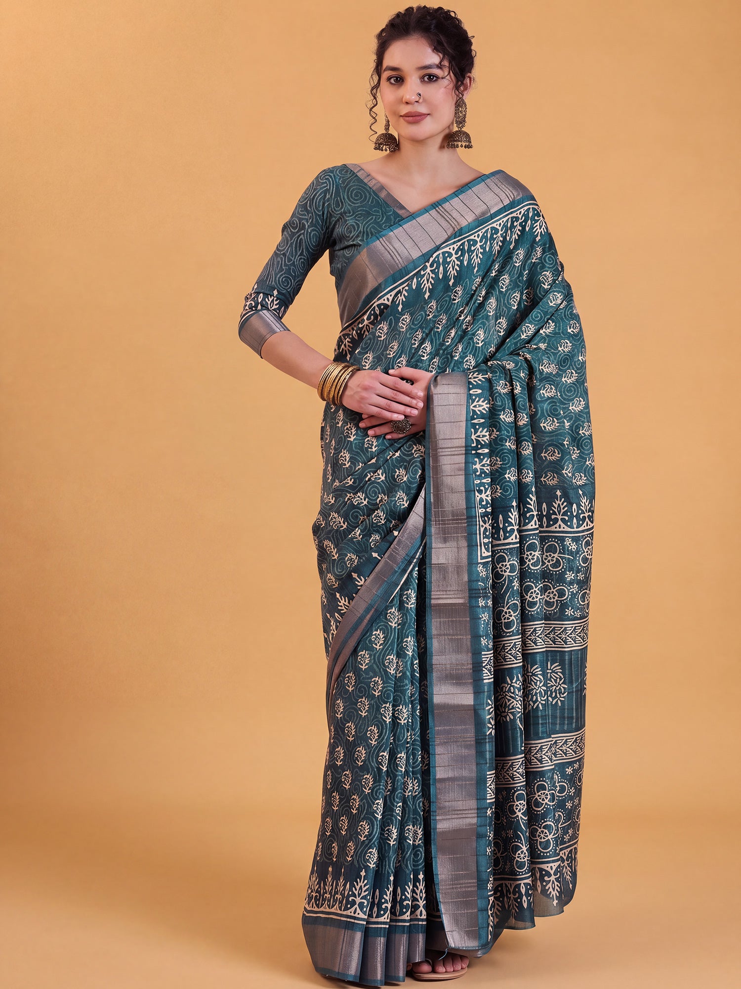 Woman wearing teal blue silk blend saree with dabu mud-resist print work and teal blue blouse