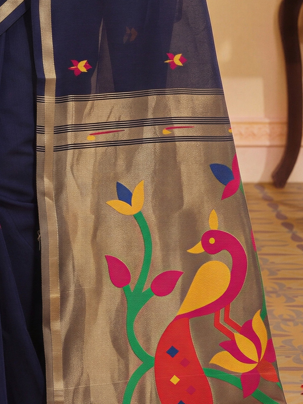 Pallu detail of navy blue silk blend saree showing traditional indian motif work and zari border