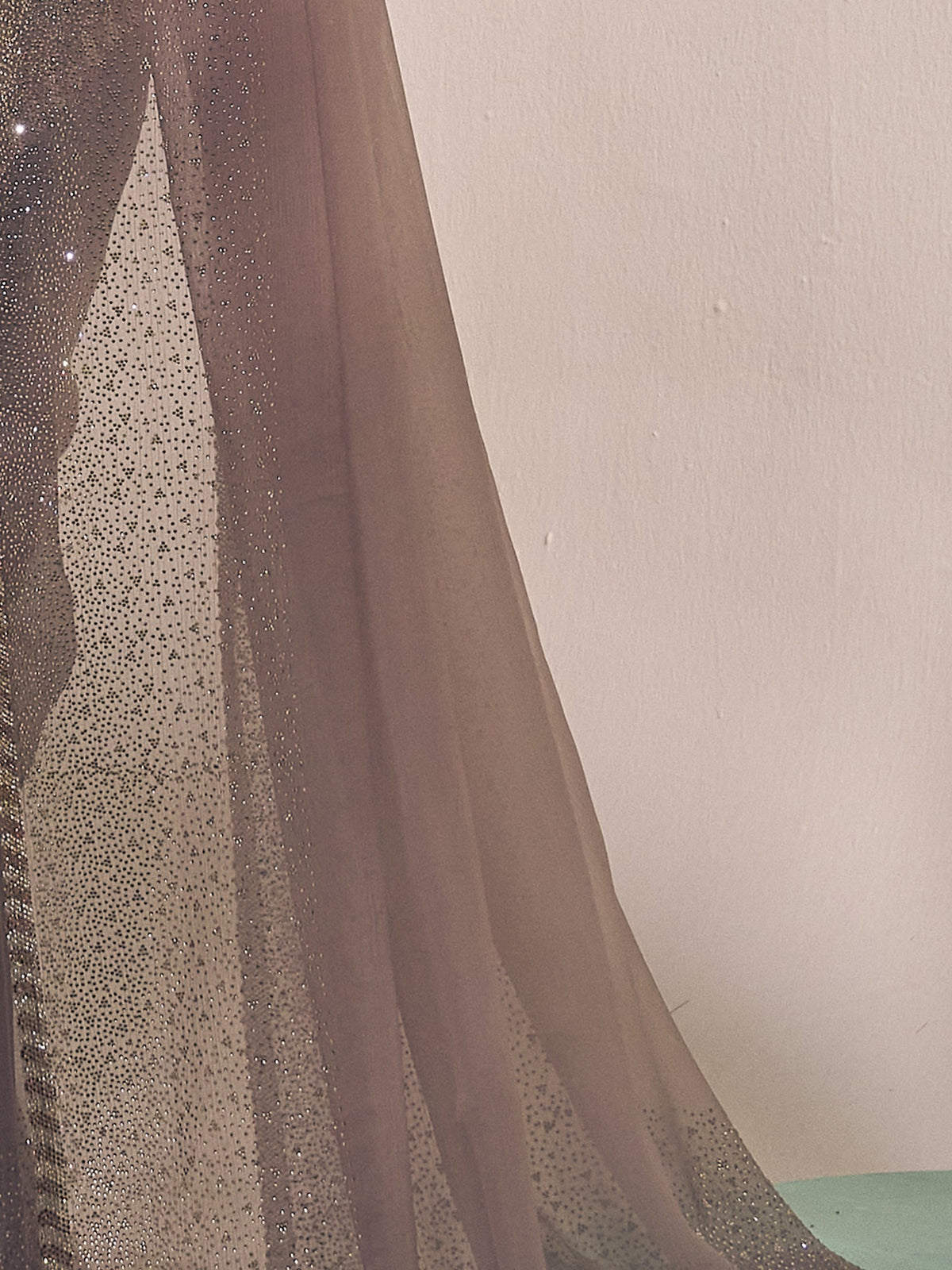 Pallu detail of grey chiffon saree showing ornamented surface design and embellished border