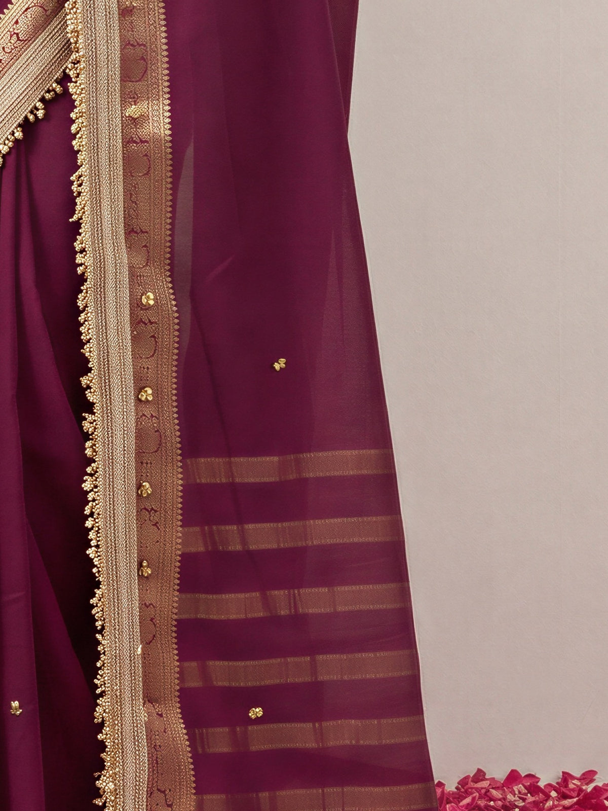 Pallu detail of wine soft silk saree showing woven motif design and zari border
