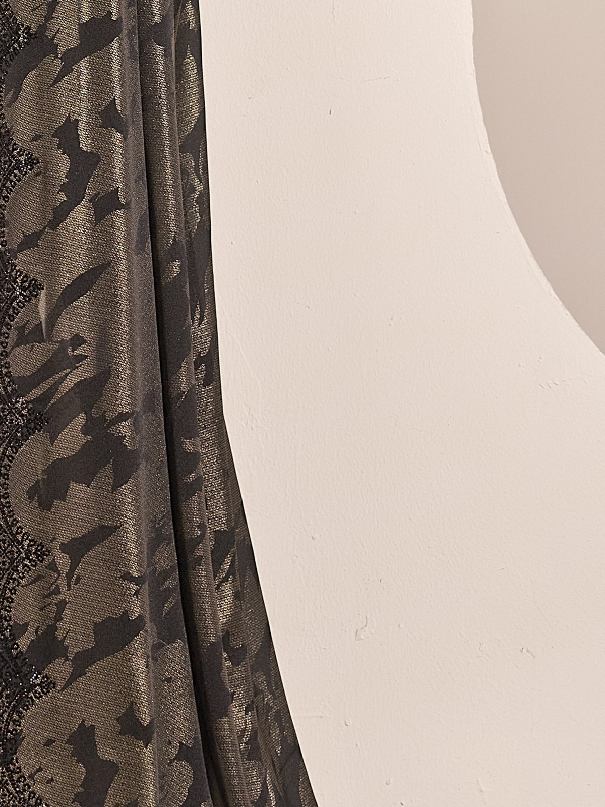 Pallu detail of black satin silk saree showing metallic foil print work and embellished border
