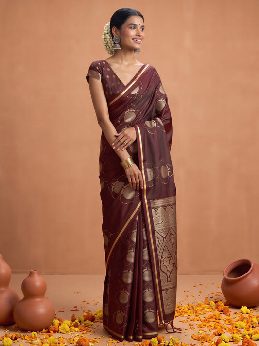 Woman wearing maroon satin saree with zari butta (metallic motif) work and maroon blouse