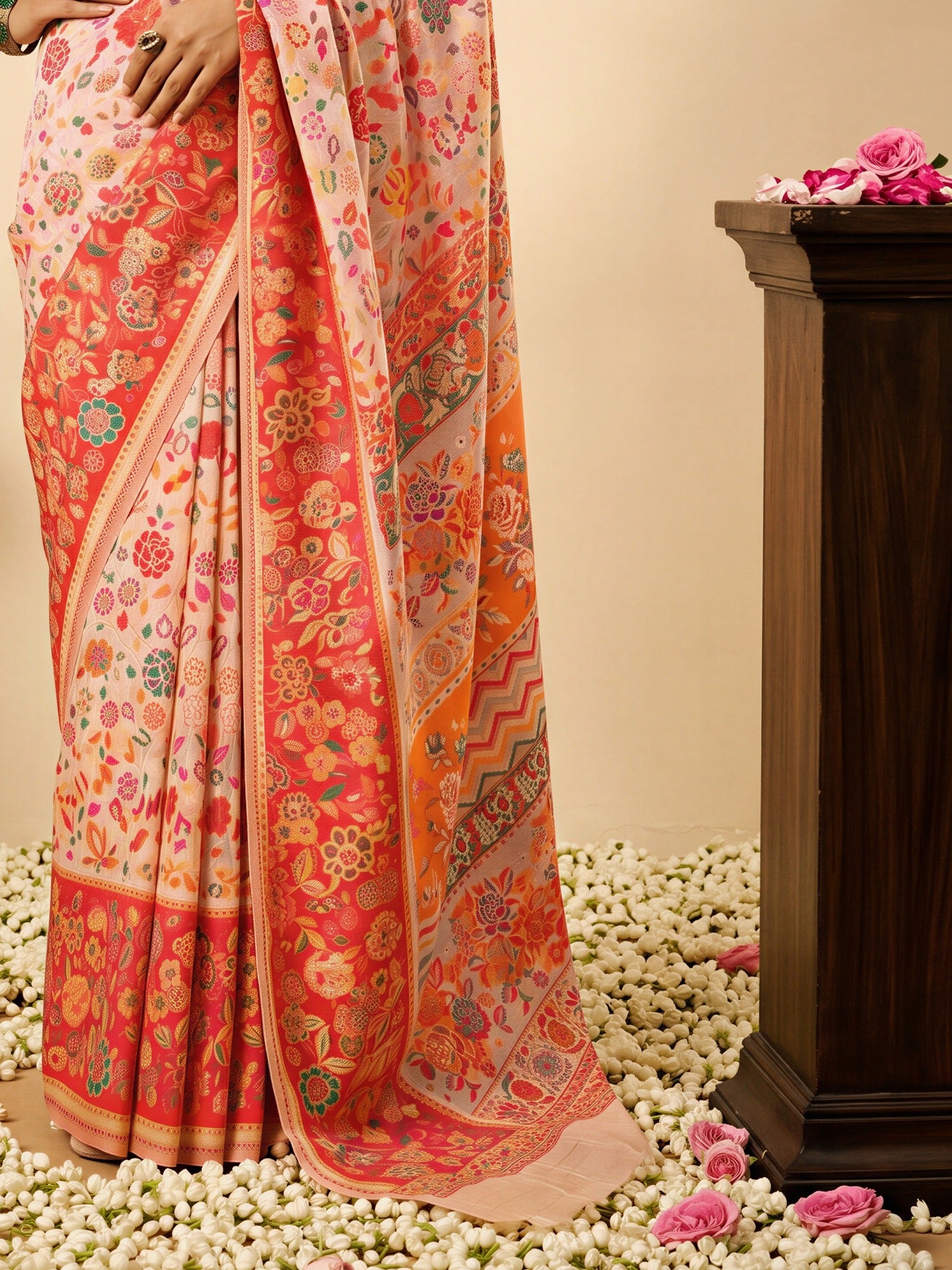 Pallu detail of peach cotton silk saree showing all-over floral design and woven design border