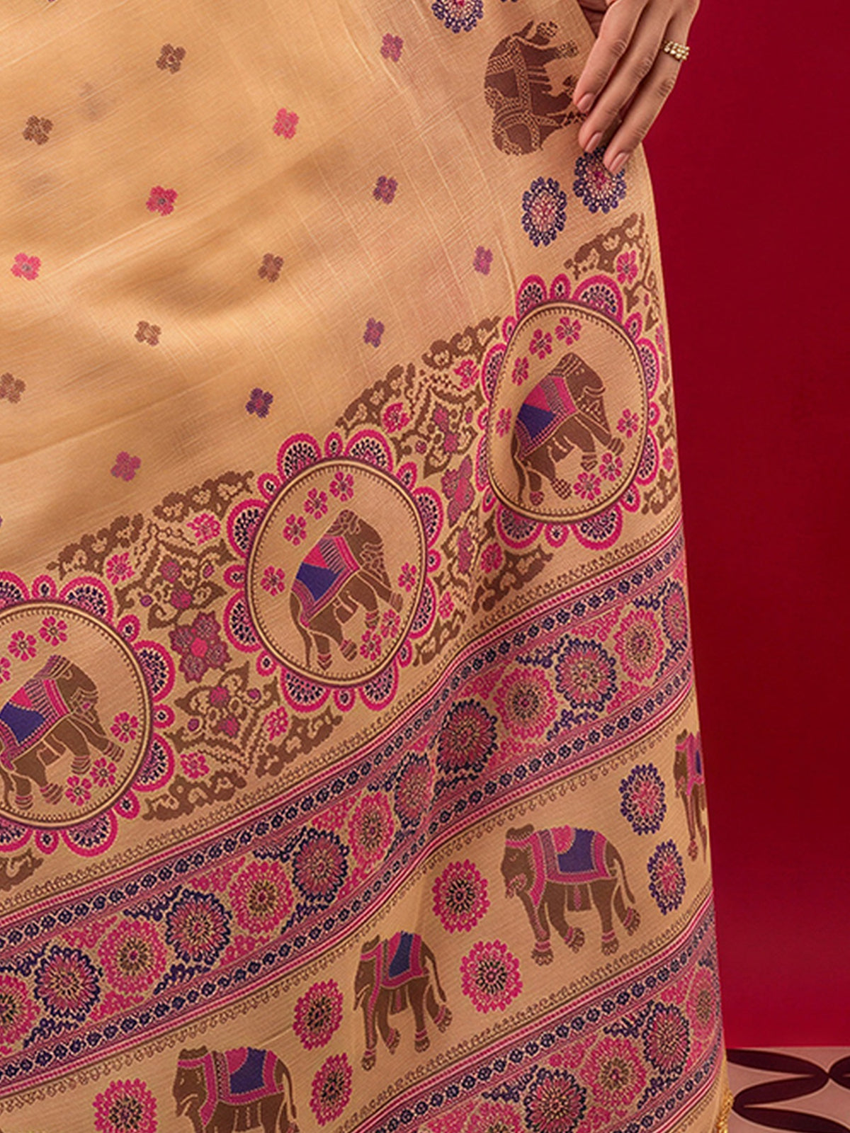 Pallu detail of peach silk blend saree showing woven motif design and woven design border