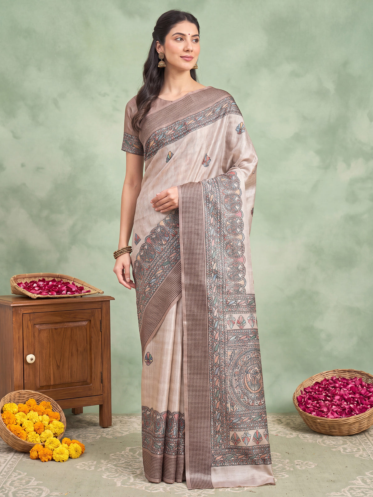 Woman wearing beige manipuri silk saree with madhubani folk-art motifs and beige blouse