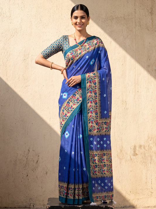 Woman wearing blue cotton saree with geometric pattern design and teal green blouse