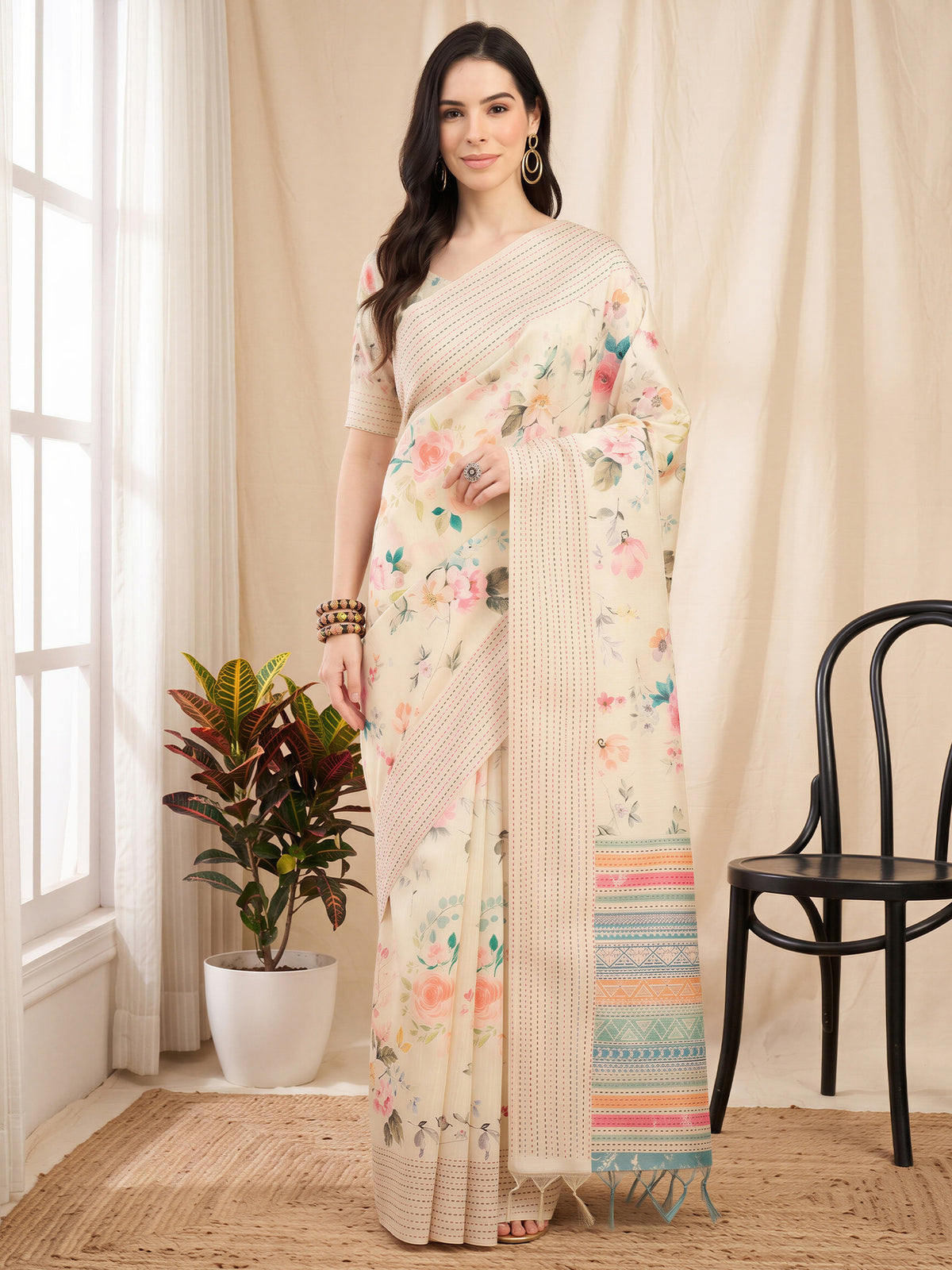 Woman wearing off white silk cotton saree with botanical floral and leaf design and off white blouse