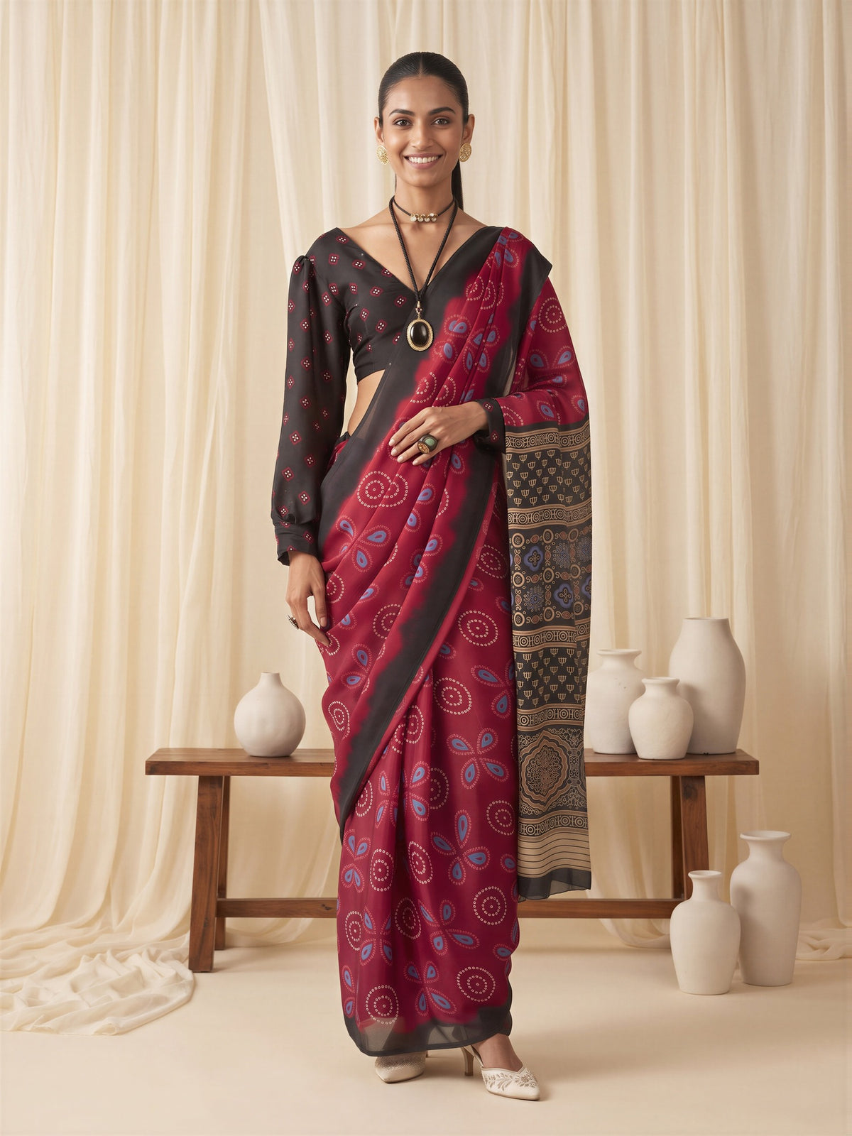 Woman wearing maroon satin saree with bagh block-print motif work and black blouse
