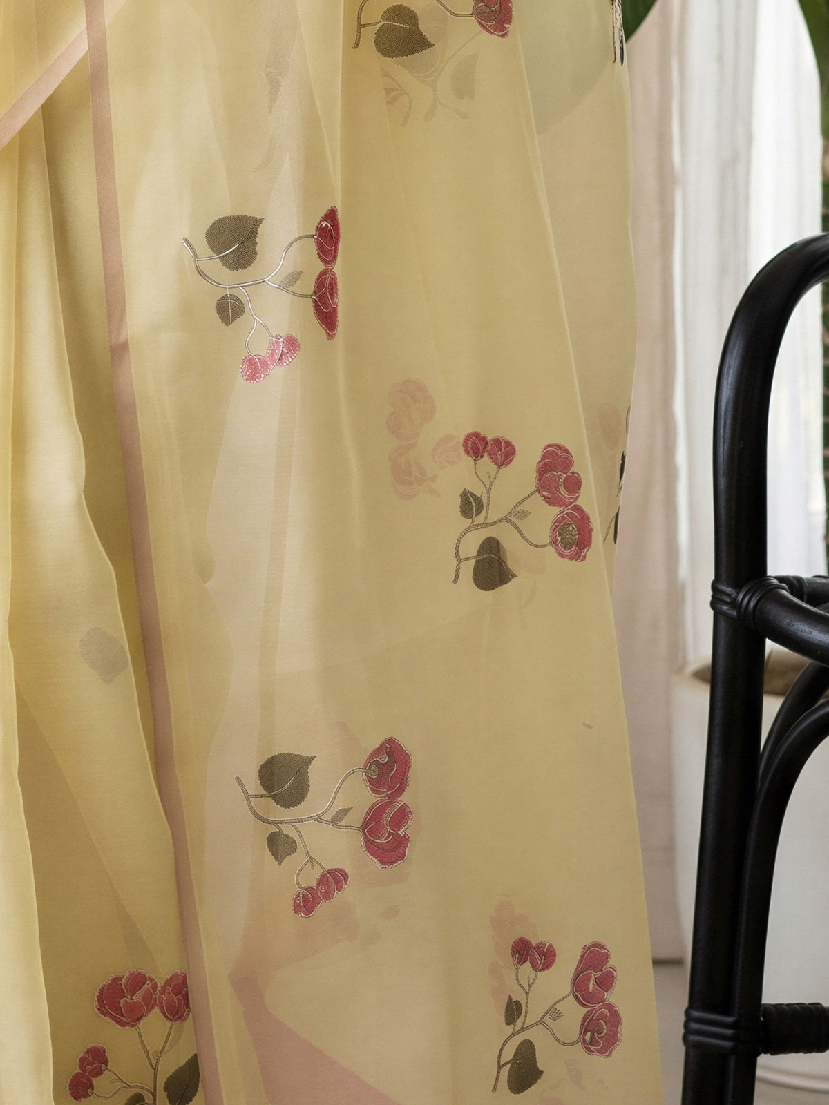 Pallu detail of yellow linen blend saree showing all-over floral design and zari border