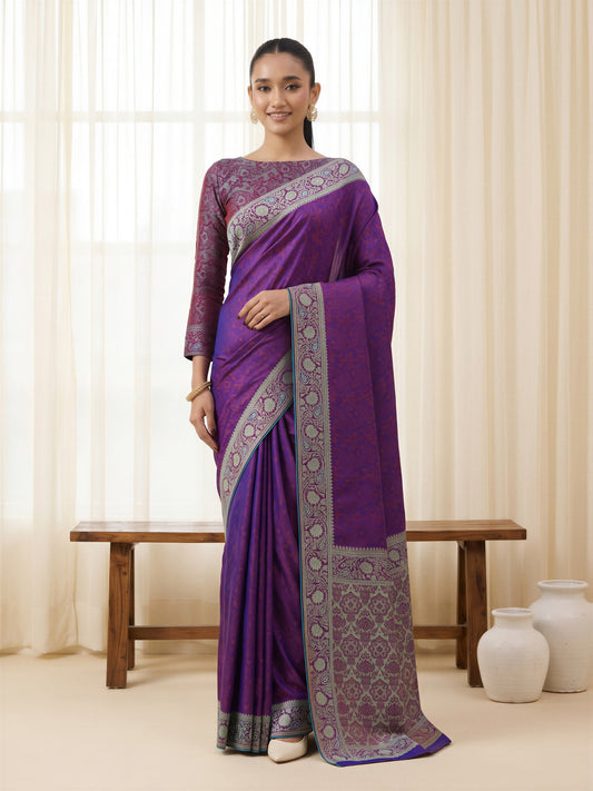 Woman wearing purple silk blend saree with traditional indian motif work and purple blouse