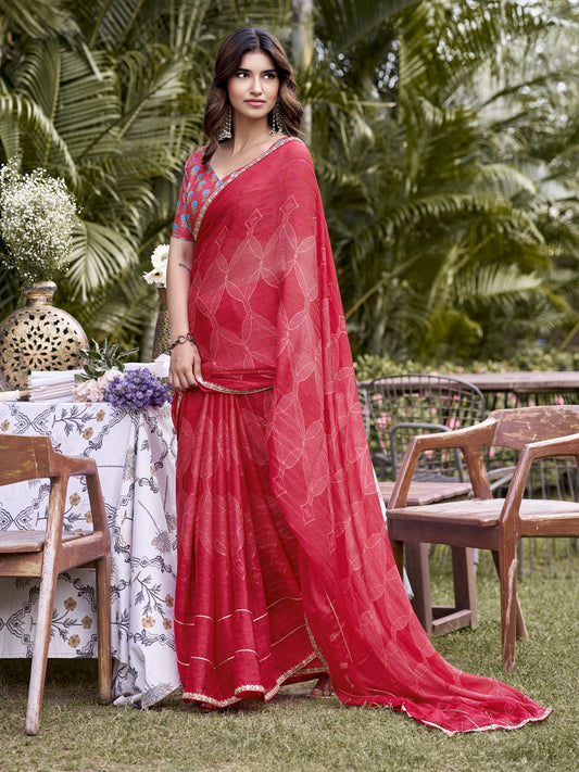 Woman wearing red chiffon saree with traditional indian motif work and red blouse