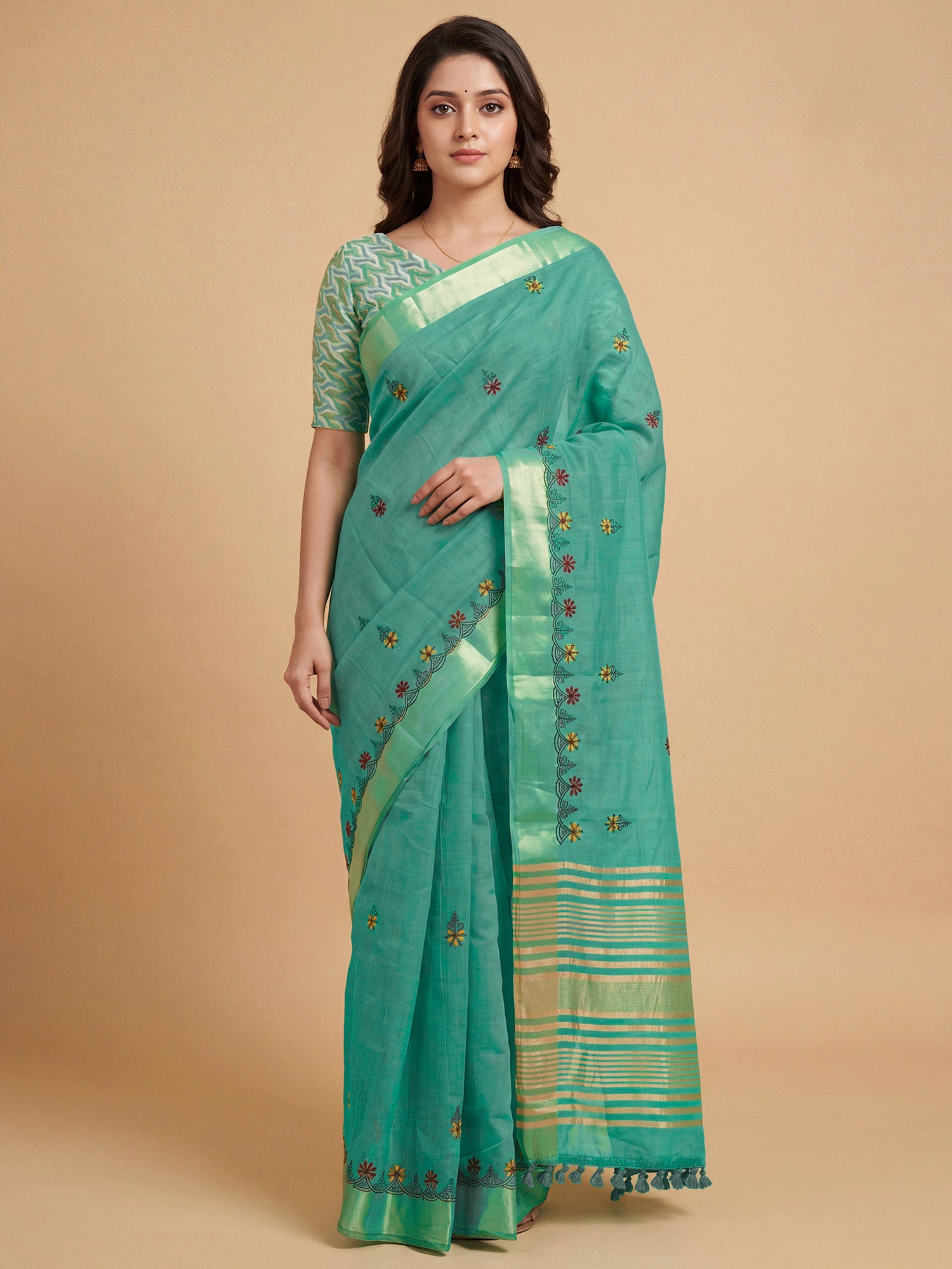 Woman wearing sea green cotton linen saree with embroidered motif work and sea green blouse