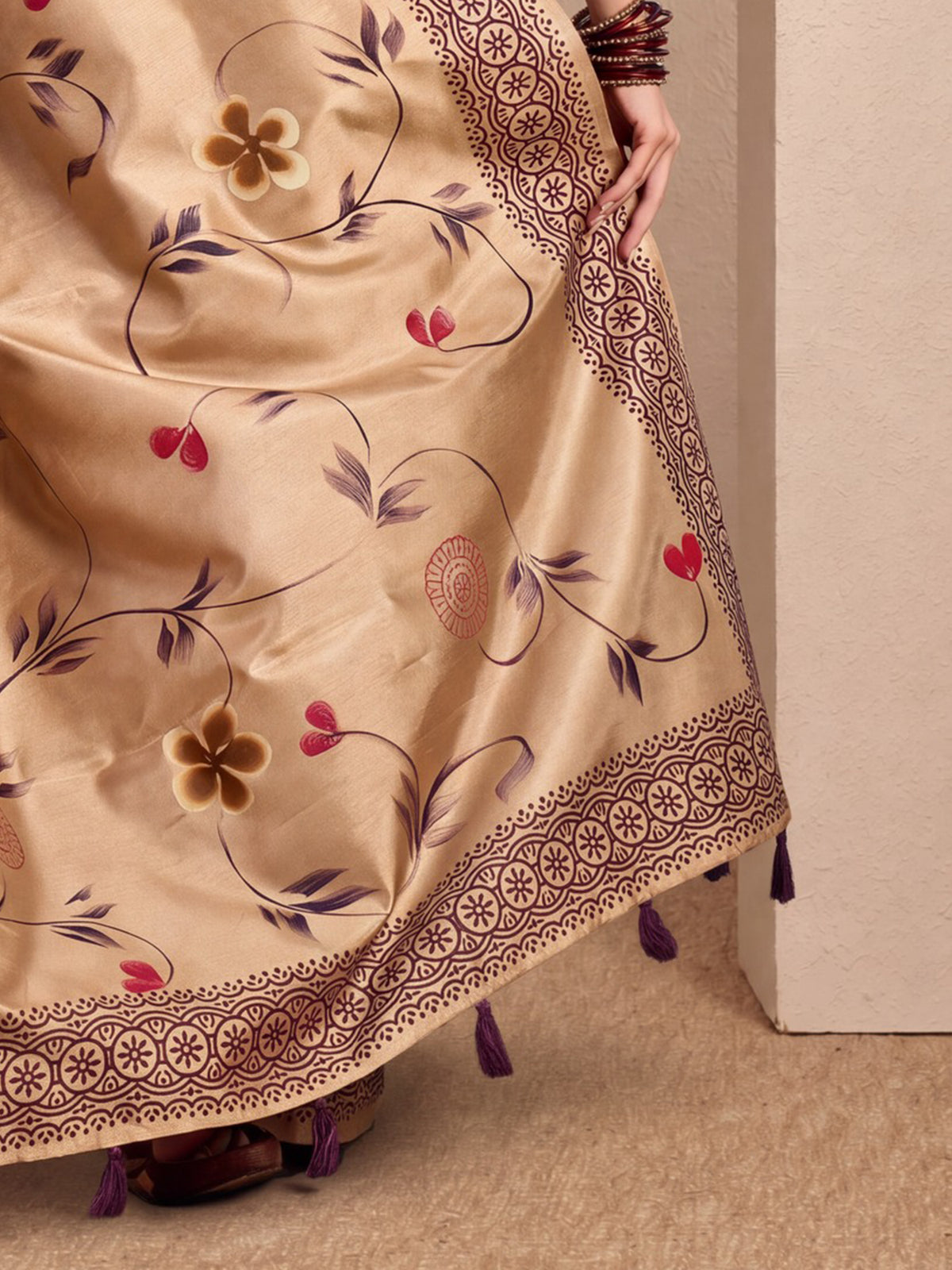 Pallu detail of beige silk blend saree showing hand-painted motif work and printed border