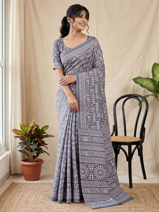 Woman wearing grey dola silk saree with warli folk-art figures and grey blouse