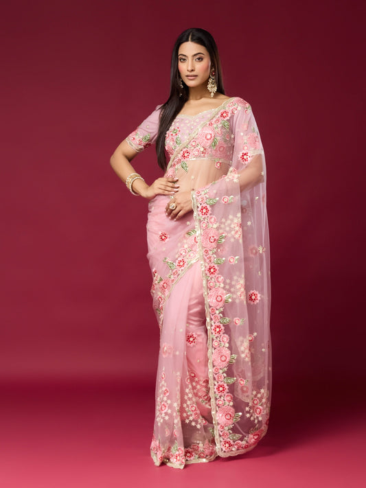 Woman wearing pink net saree with embroidered motif work and pink blouse